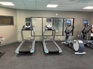 A gym with treadmills, ellipticals, and a stationary bike. - La Quinta Inn & Suites by Wyndham Duluth/Atlanta (Duluth)