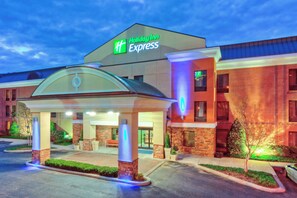 A Holiday Inn Express hotel with a covered entrance, brick facade, and illuminated signage. - Holiday Inn Express & Suites Nashville - Brentwood I-65 by IHG (Brentwood)