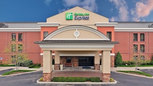 A Holiday Inn Express building with a brick facade, a central entrance with a canopy, and a clear sky. - Holiday Inn Express & Suites Nashville - Brentwood I-65 by IHG (Brentwood)
