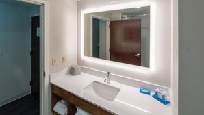 A bathroom with a white sink, a mirror with a light, and a wooden vanity. - Holiday Inn Express & Suites Nashville - Brentwood I-65 by IHG (Brentwood)