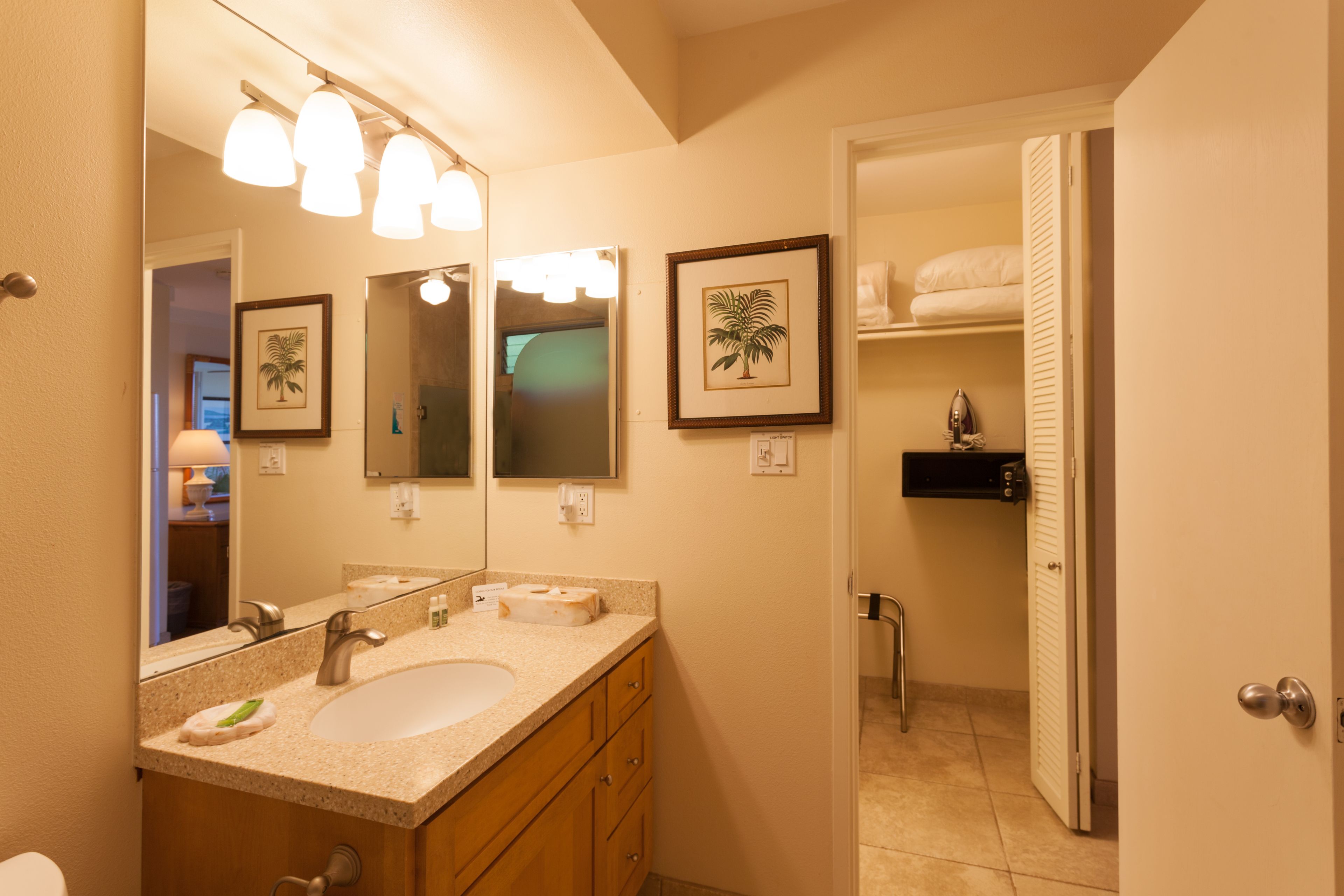 A bathroom with a sink, mirror, and towel rack.