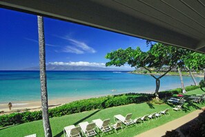 A beach view with lounge chairs and a clear sky. - Napili Sunset on the Beach (Lahaina)