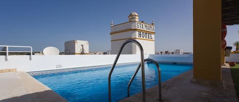 Outdoor pool, open 10:00 AM to 9:00 PM, pool umbrellas, pool loungers