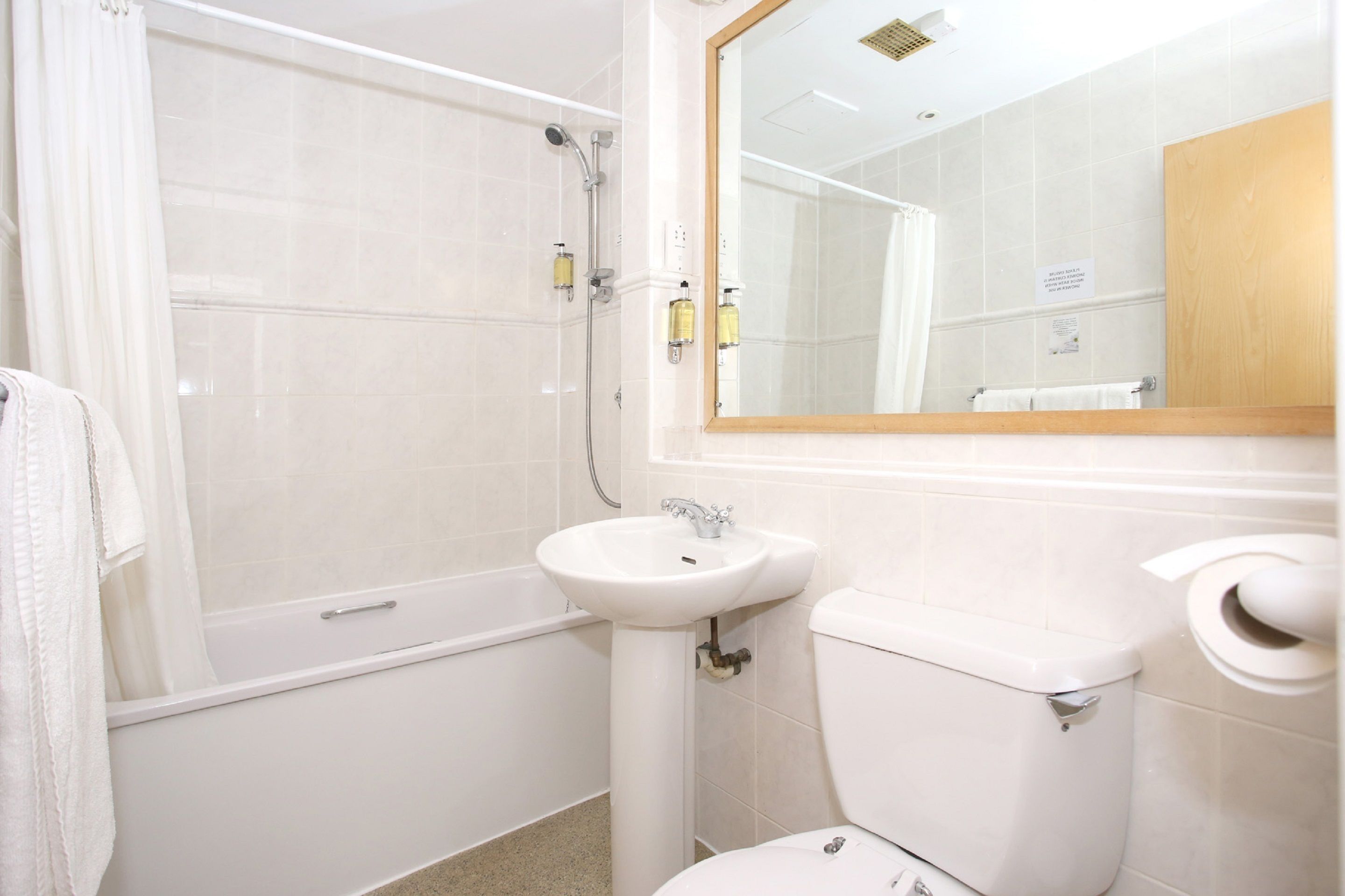 A bathroom with a bathtub, a sink, and a toilet.