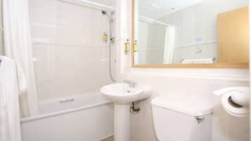 A bathroom with a bathtub, a sink, and a toilet.