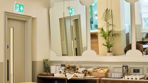 A hotel lobby with a reception desk, a large mirror, and several chairs. - The Edwin Hotel (London)