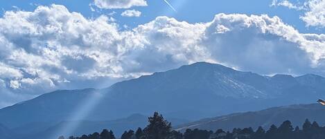 A mountain range with a clear sky and scattered clouds.