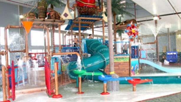 An indoor water park with slides and play structures. - Bayside Hotel of Mackinac (Mackinaw City)