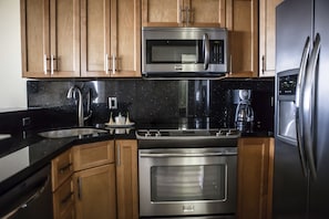 Deluxe Room, Multiple Beds | Private kitchen | Full-size fridge, microwave, coffee/tea maker, cookware/dishes/utensils
