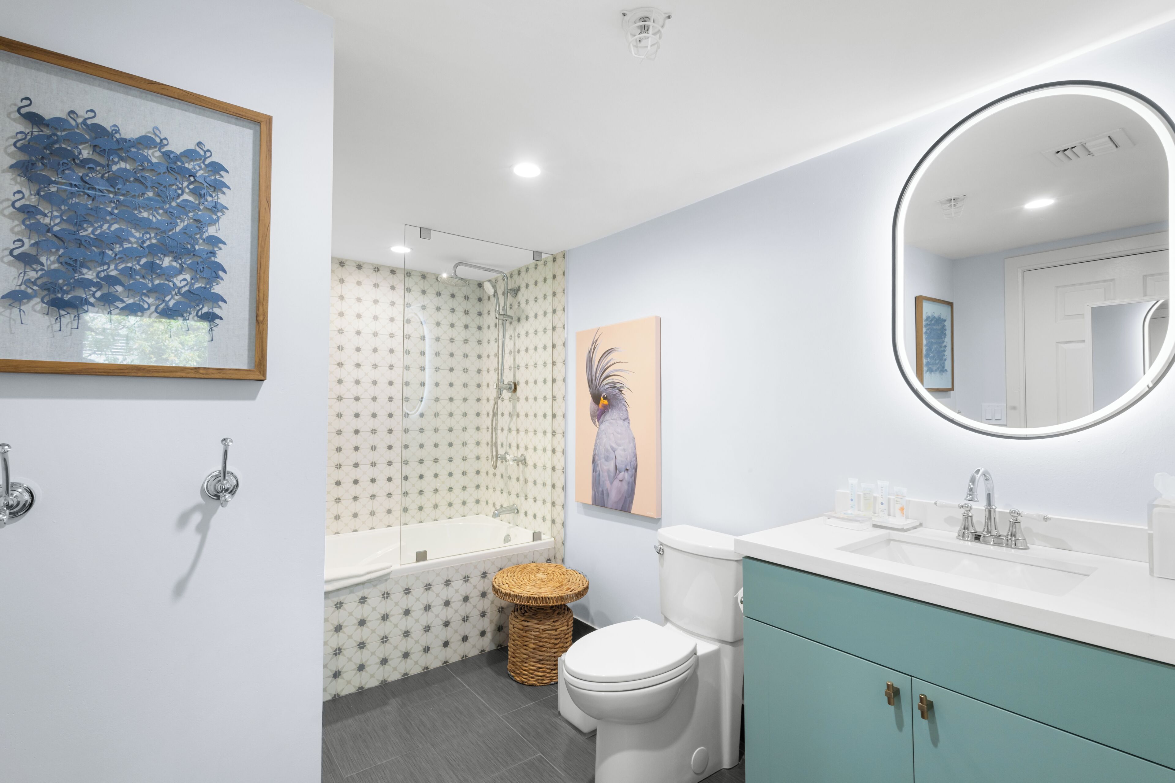 A modern bathroom with a bathtub, toilet, and sink.