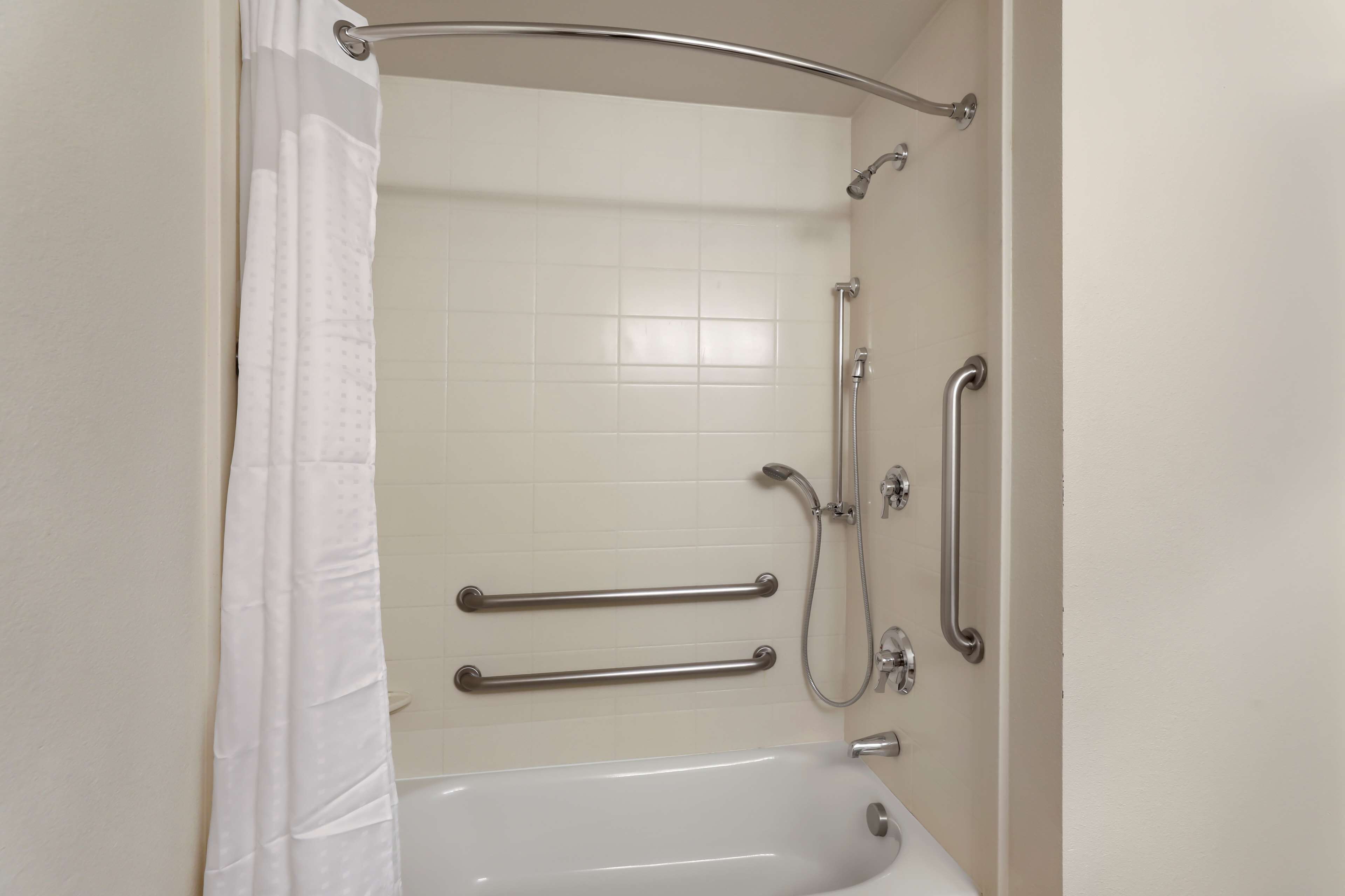 standard room, 1 king bed, accessible, refrigerator & microwave | bathroom | combined shower/bathtub, free toiletries, hair dryer, towels