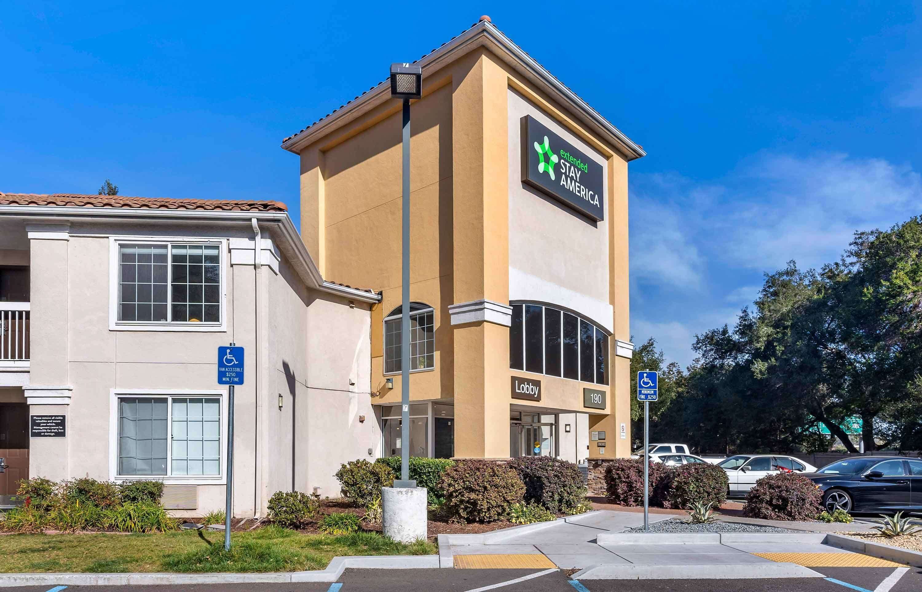 A hotel with a sign for 'Extended Stay America' and a lobby entrance marked '190'.
