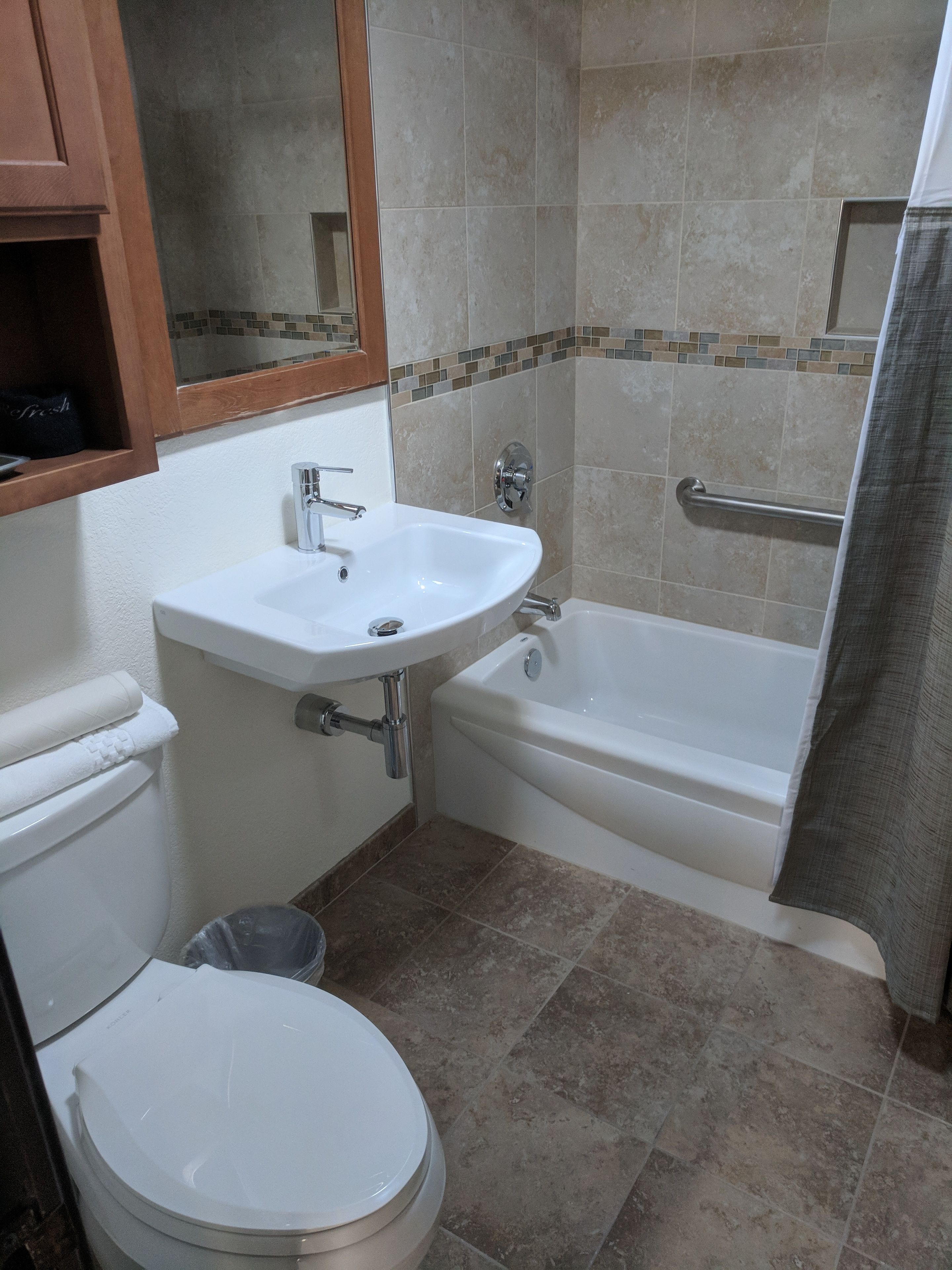 A bathroom with a toilet, sink, and bathtub.