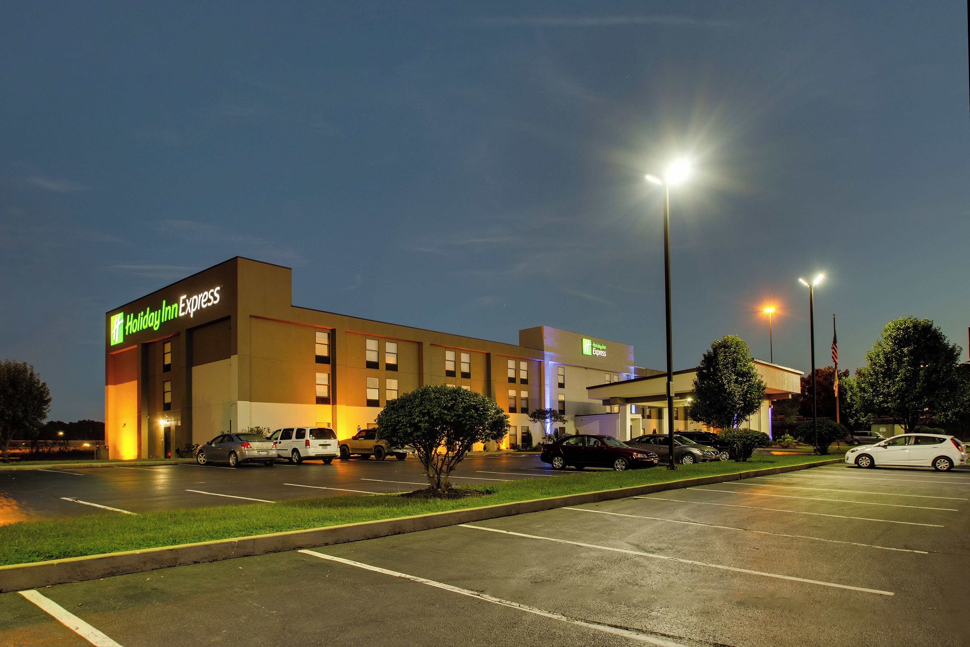 A Holiday Inn Express hotel with a parking lot and a well-lit facade.