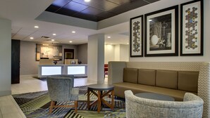 A lobby with a sofa, chairs, a small table, and framed artwork on the wall. - Holiday Inn Express Horse Cave by IHG (Horse Cave)