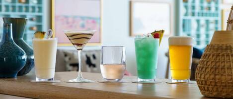 A bar area with various drinks and a decorative vase.