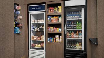 A refrigerated display case labeled "REALLY COLD" with snacks and beverages.