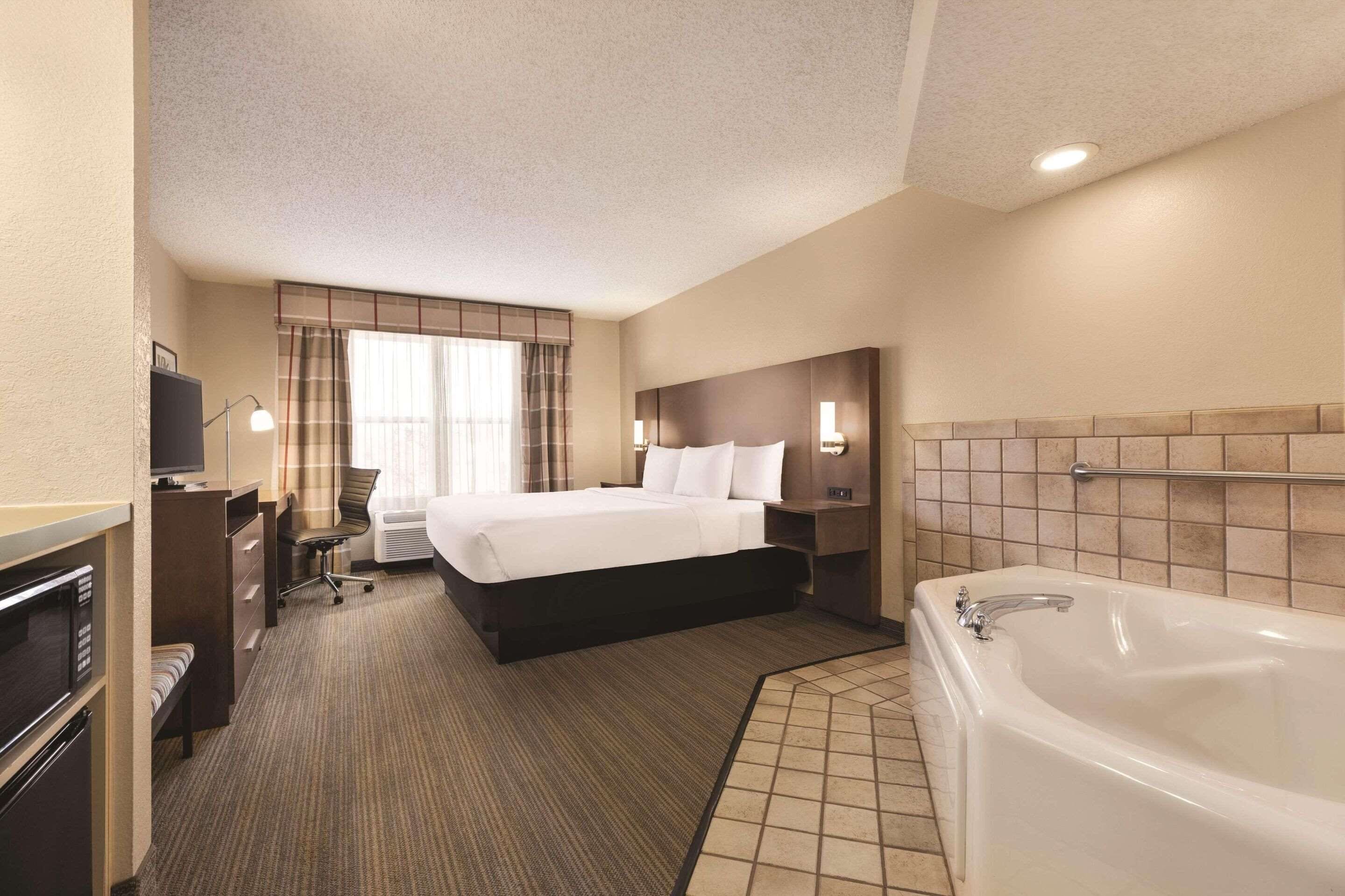 Premium bedding, desk, laptop workspace, iron/ironing board