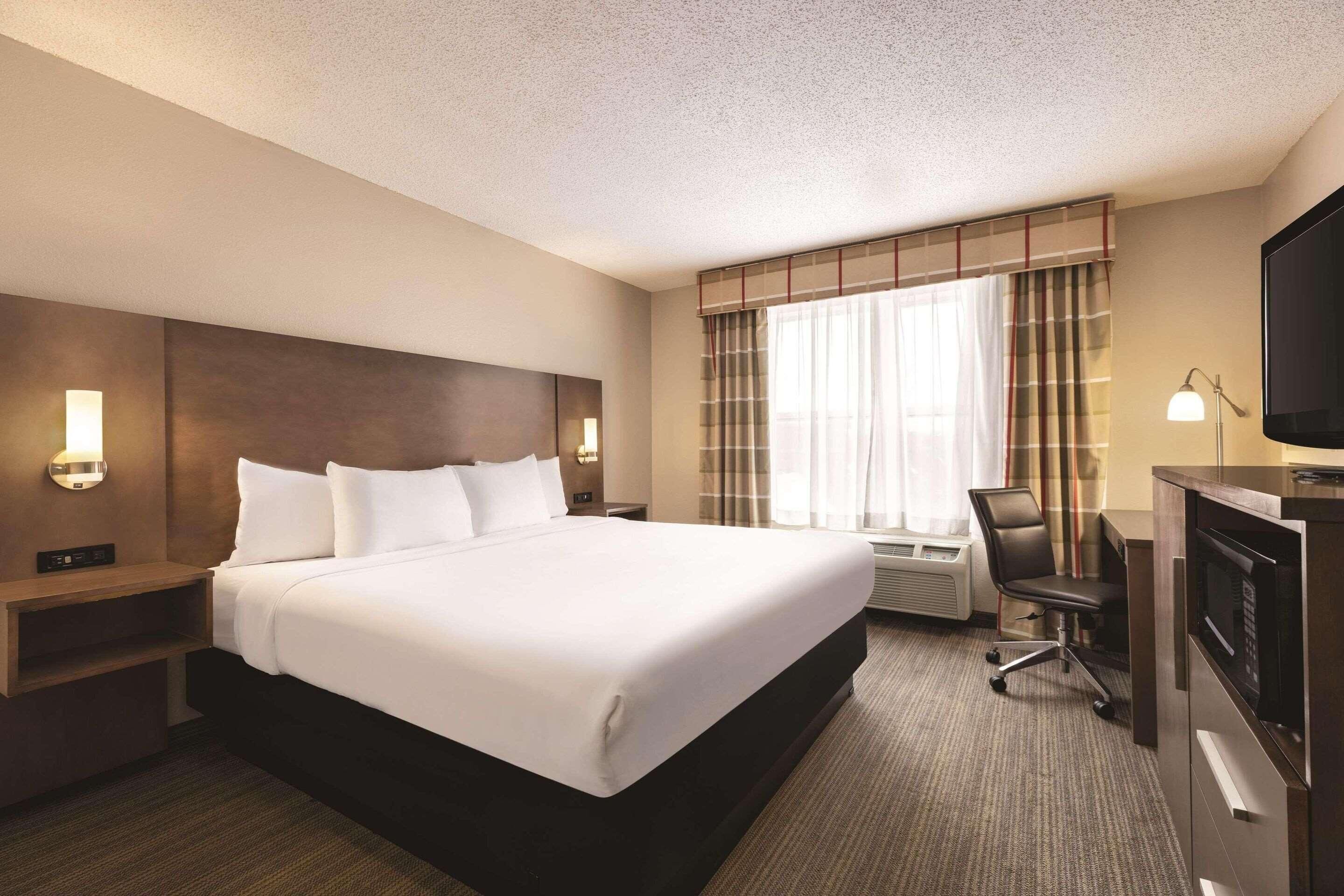 Premium bedding, desk, laptop workspace, iron/ironing board