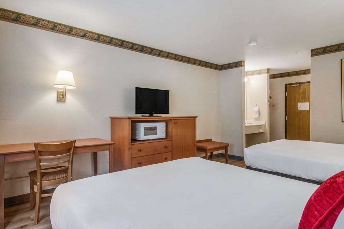 Premium bedding, desk, laptop workspace, blackout drapes