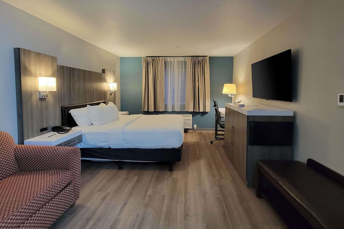 Premium bedding, desk, laptop workspace, blackout drapes