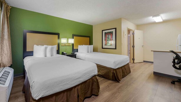 A hotel room with two beds, a desk, a chair, and a picture on the wall. - Extended Stay America Suites Ft Lauderdale Cyp Crk Andrews A (Oakland Park)