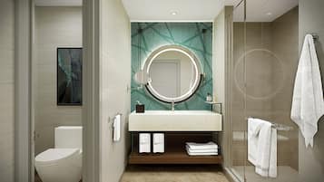 A modern bathroom with a toilet, sink, and shower.