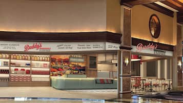 A bakery with a sign reading "Buddy's Boardwalk Empire" and a variety of baked goods on display.