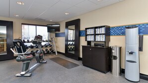 A gym with exercise equipment, a water dispenser, and a mirror. - Hampton Inn Detroit/Auburn Hills South (Auburn Hills)