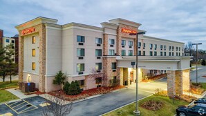 A Hampton Inn hotel with a brick facade, multiple windows, and a well-lit entrance. - Hampton Inn Detroit/Auburn Hills South (Auburn Hills)