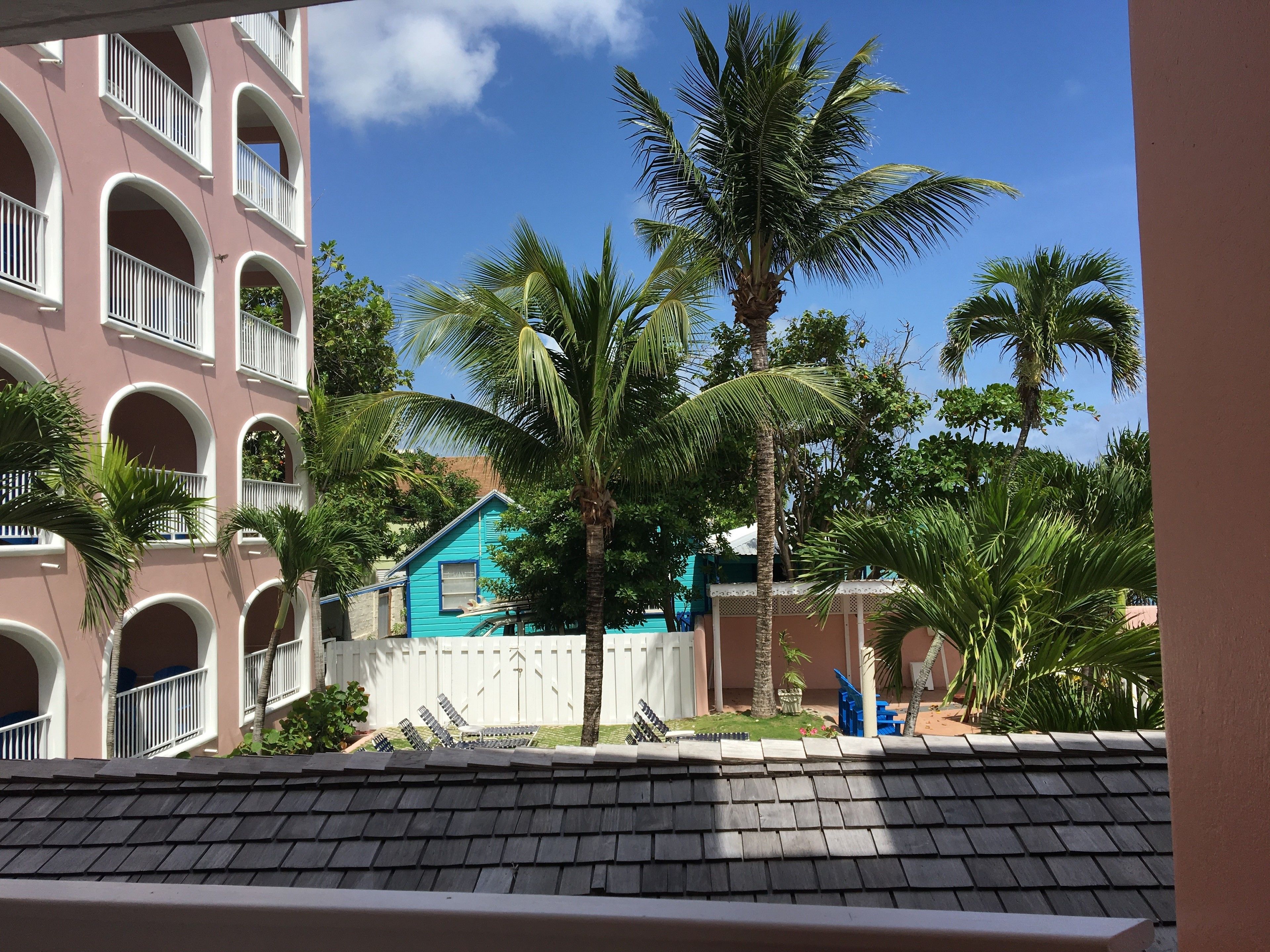 A building with balconies and a pool area.