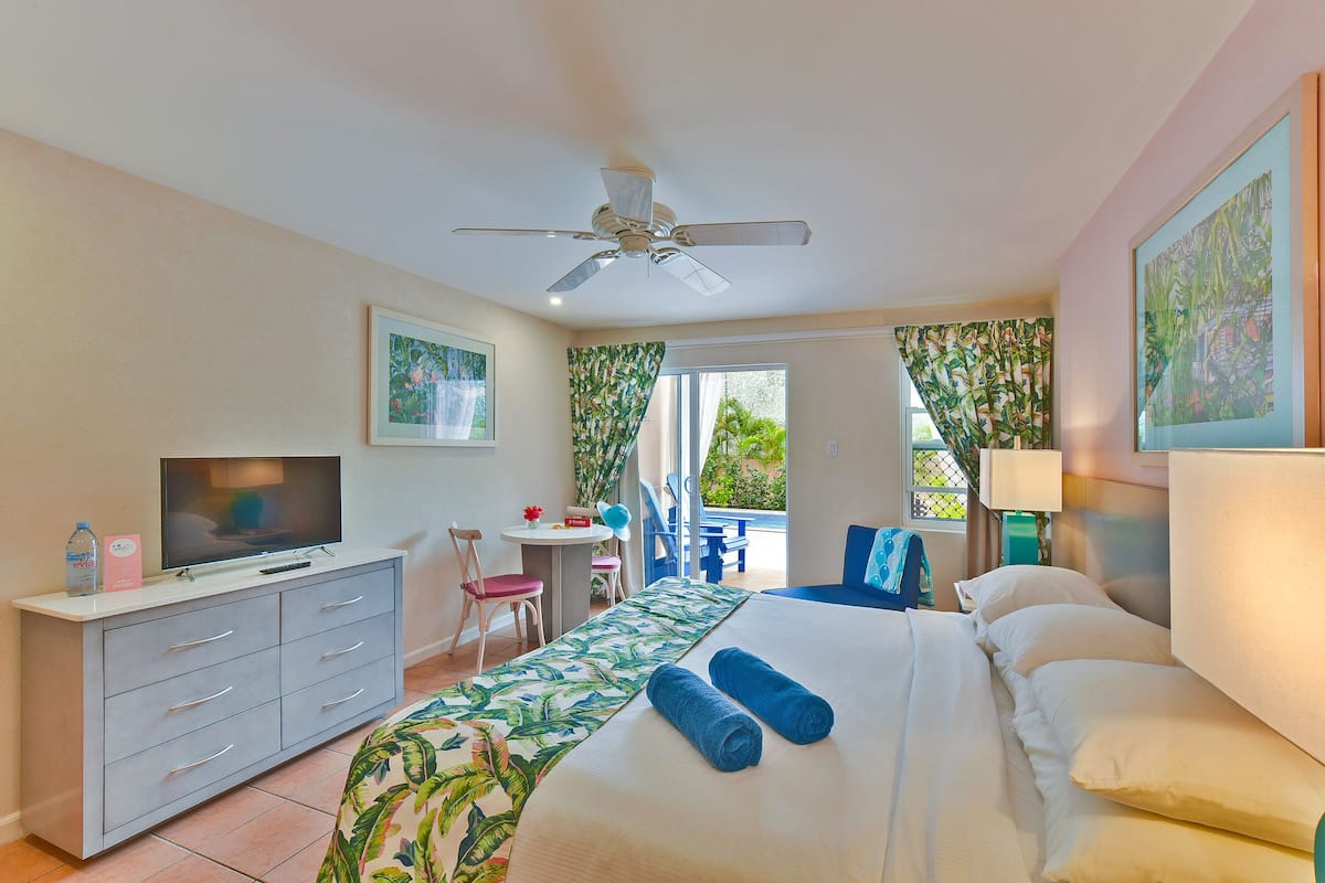 Deluxe Studio, Pool View | In-room safe, desk, laptop workspace, blackout curtains