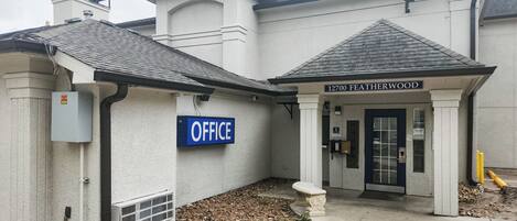 A building with a sign reading "12700 Featherwood" and an "OFFICE" sign.