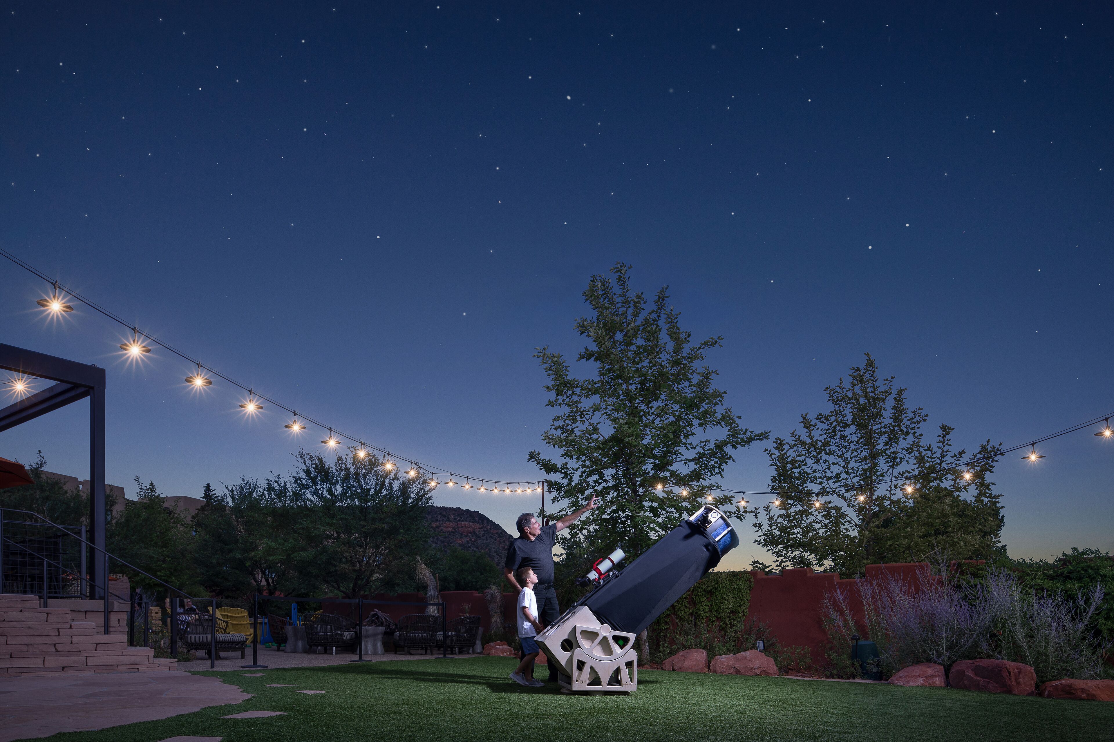 A telescope set up in an outdoor area with a clear night sky.