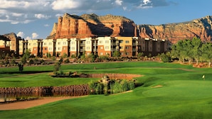 A golf course with a large building in the background. - Hilton Sedona Resort at Bell Rock (Sedona)