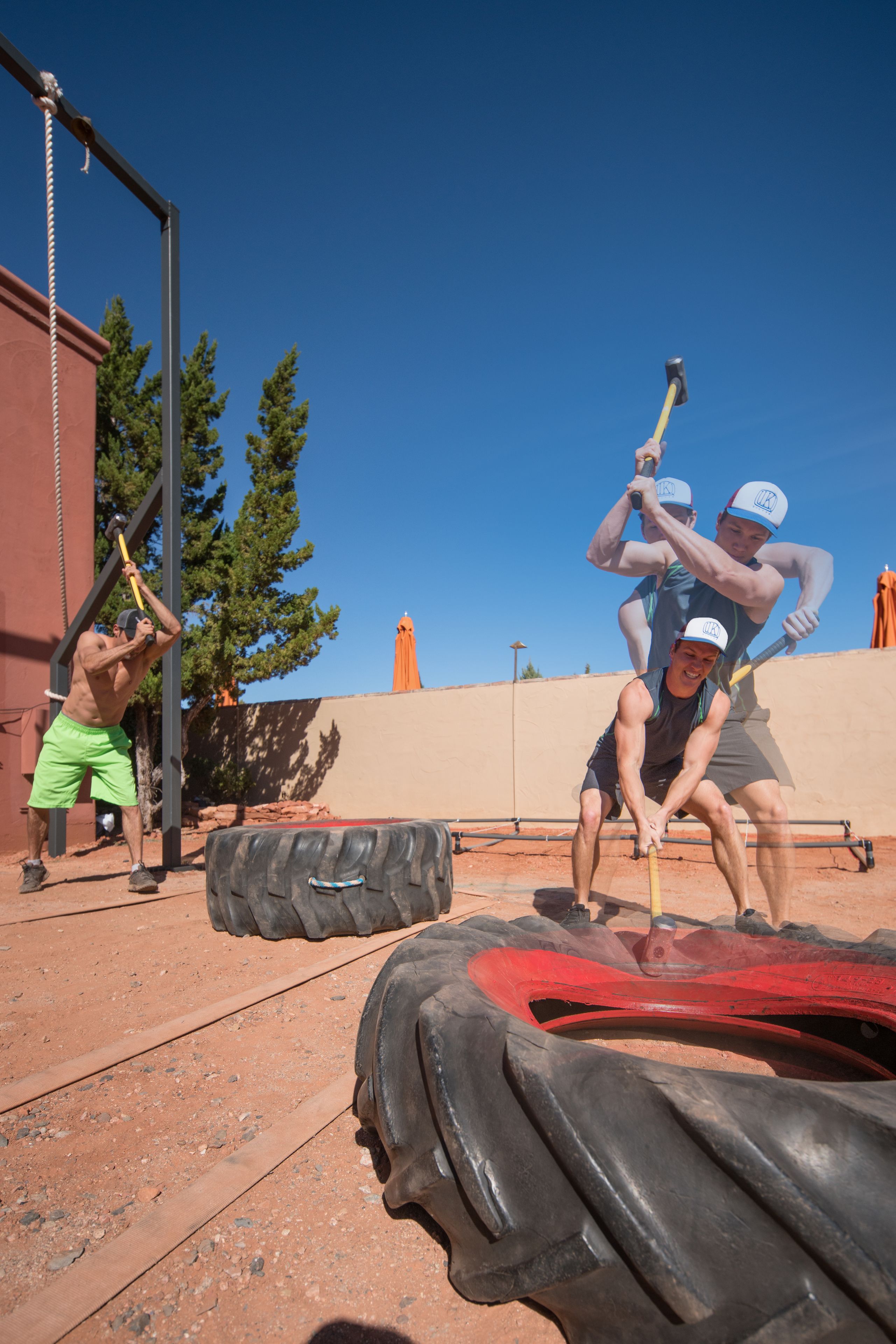 A gym with exercise equipment, including a tire and a barbell.