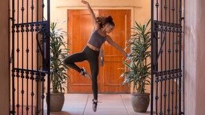 A person performing a dance move in front of a metal gate with potted plants on either side. - Hilton Sedona Resort at Bell Rock (Sedona)