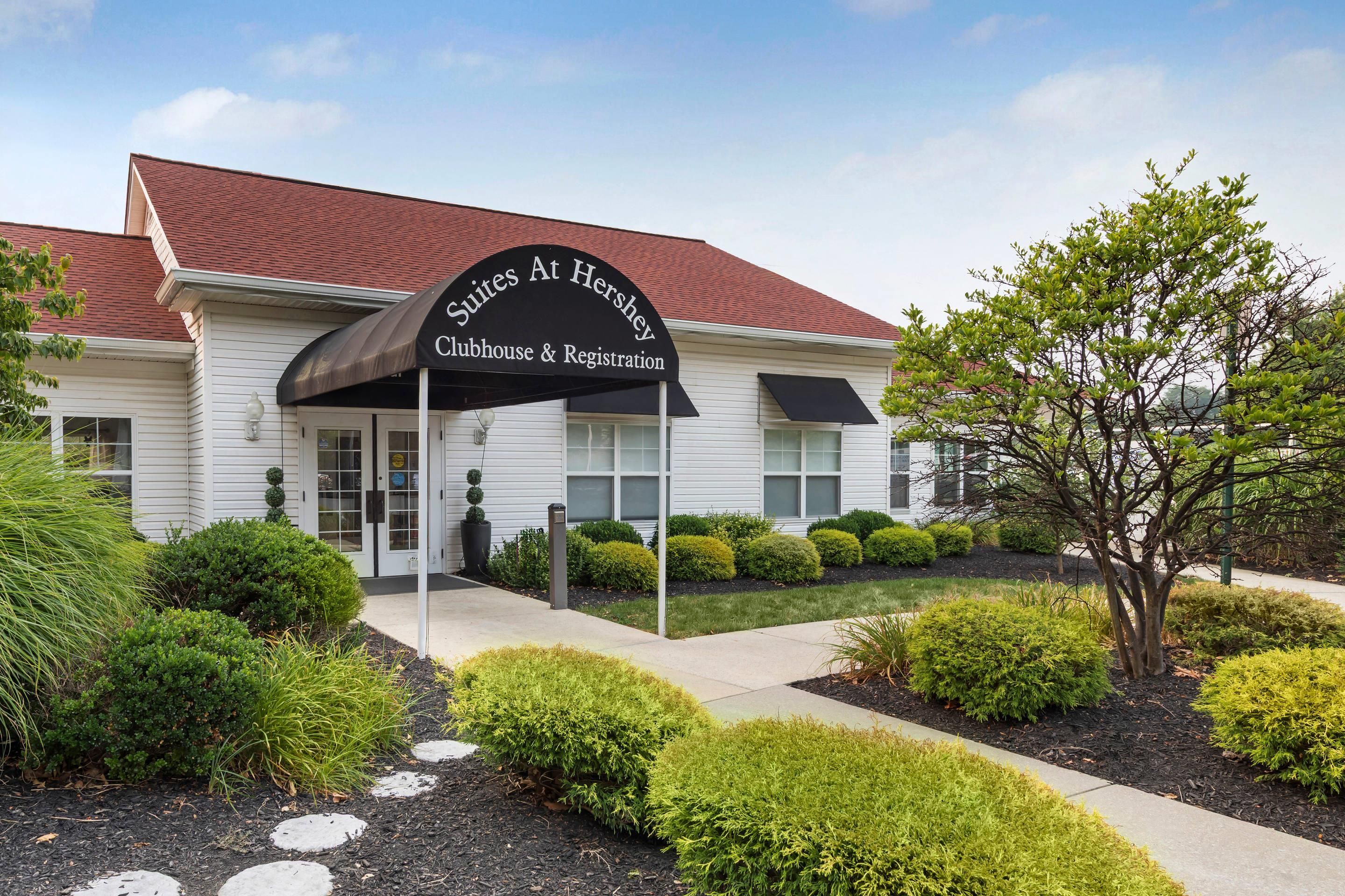 A building with a sign reading 'Suites At Hershey Clubhouse & Registration.'