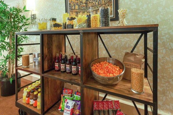 A buffet table with various food items and condiments.