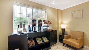 A reception area with a coffee station, seating, and a window with blinds. - Extended Stay America Suites North Chesterfield Arboretum (Richmond)