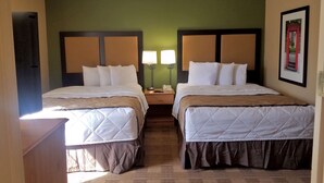 A hotel room with two beds, each with a headboard, bedside lamps, and a framed picture on the wall. - Extended Stay America Suites Kansas City Overland Pk Nall Av (Overland Park)