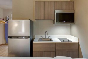 Full-sized fridge, microwave, stovetop, coffee/tea maker