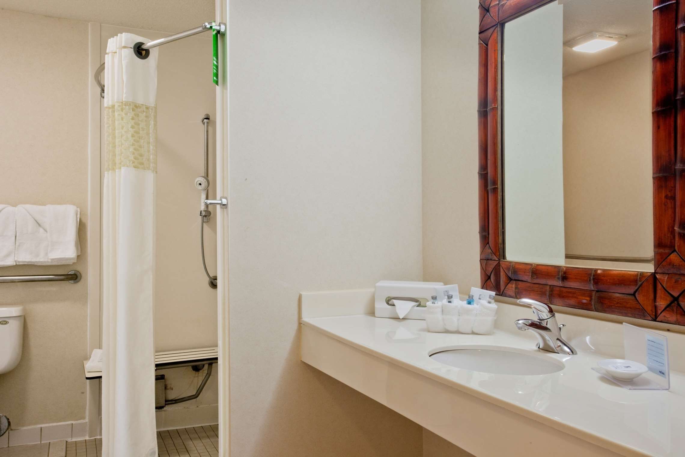 A bathroom with a shower, toilet, and sink.