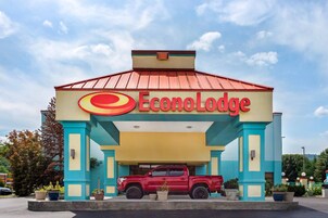 Un edificio con techo rojo y un letrero que dice 'Econo Lodge'.