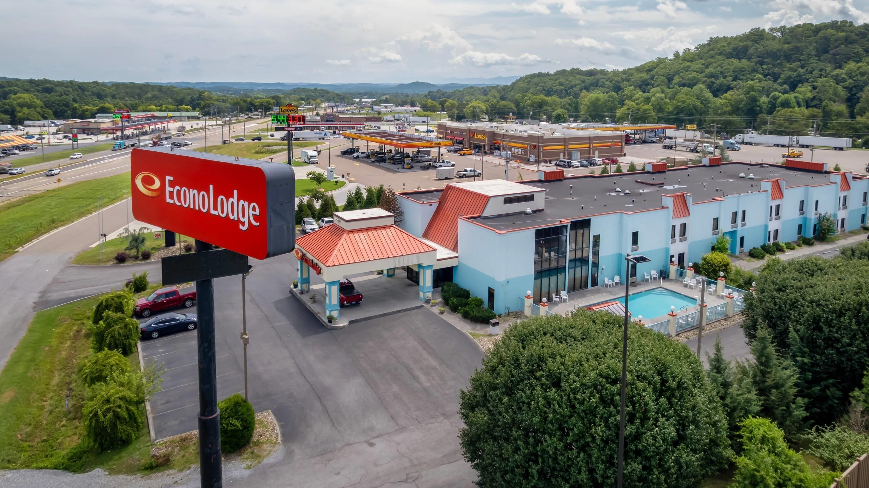 Un motel con piscina, estación de servicio y amplio estacionamiento.