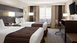 A hotel room with two beds, a desk, a chair, a TV, and a window with curtains. - Country Inn & Suites by Radisson, San Antonio Lackland AFB - SeaWorld Area (San Antonio)