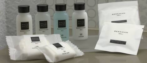 A selection of skincare products from the Beekman White Water Collection, including a facial bar, lotion, and a remover wipe.