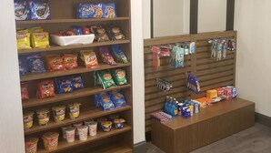 A snack display with various brands like Cheez-It, Ritz, and Doritos. - Holiday Inn Express Columbia NE - Fort Jackson by IHG (Columbia)