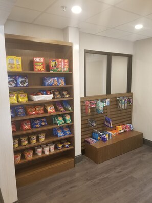 A snack display with various brands like Cheez-It, Ritz, and Doritos. - Holiday Inn Express Columbia NE - Fort Jackson by IHG (Columbia)