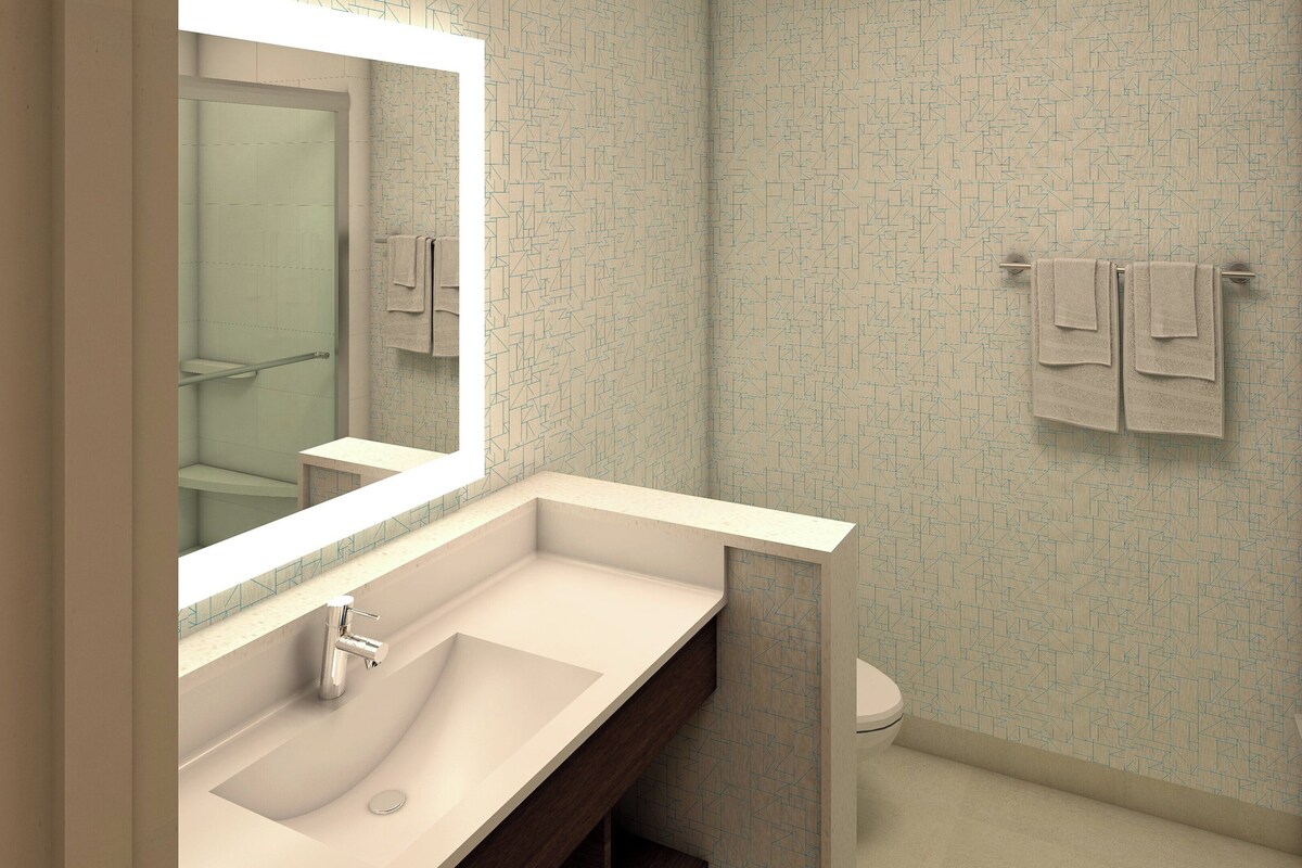 A bathroom with a sink, mirror, towel rack, and toilet.